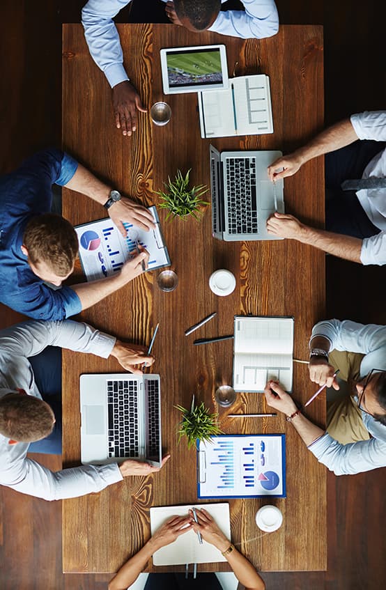 Team collaborating around a table, top-down view